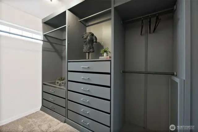 Custom Closet in primary bedroom with natural light.