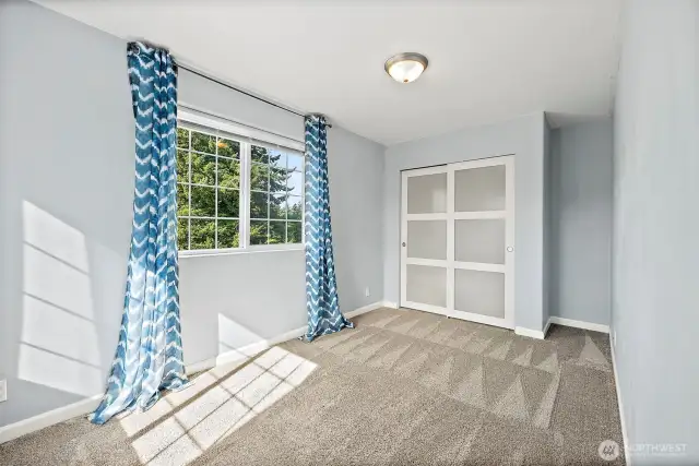 Fifth bedroom located upstairs with double windows for abundant daytime light.