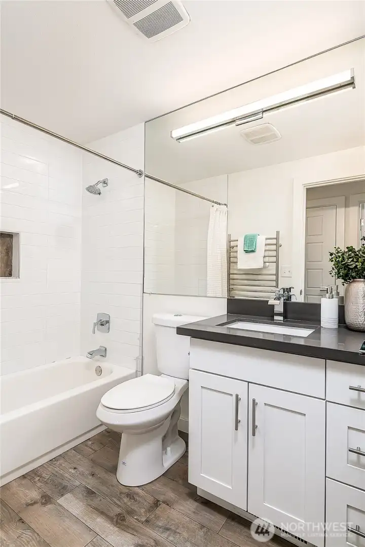 Full bath in hallway of upper level just off bedrooms #2 & 3.