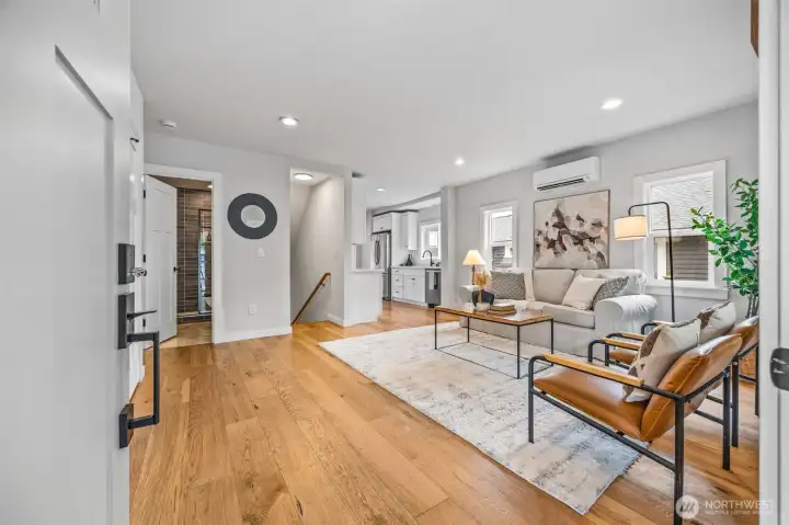 Stunning entry into main living with wide-plank oak flooring throughout.