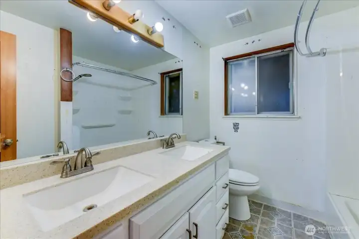 The bath is partially remodeled with a new vanity and door