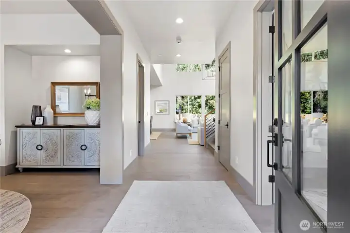 Greet your guests at the covered front porch and welcome them into your wonderful home. Spacious, wide entry foyer with the formal dining room on the left and office on the right. Warm wide-plank engineered oak hardwood flooring throughout the main level.