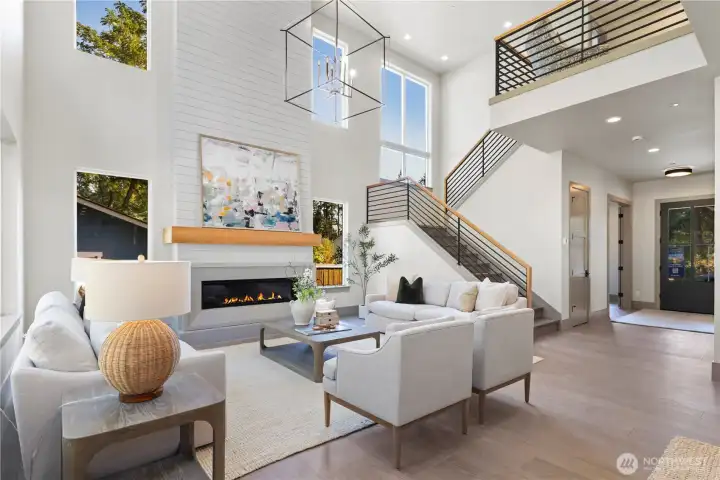View back to the entry foyer and open staircase leading to the second floor. 10' ceilings on the main floor and 8' doors on the both levels. Large storage space under the stairway. This home also has great natural lighting with its many oversized windows.
