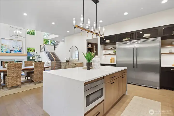 Eye-catching Frigidaire® Pro series side-by-side built-in refrigerator and freezer. Gorgeous open shelving with led accent lighting, slab quartz countertops and backsplash. Sleek glass-front upper cabinets that bring a touch of refinement and display-worthy style.