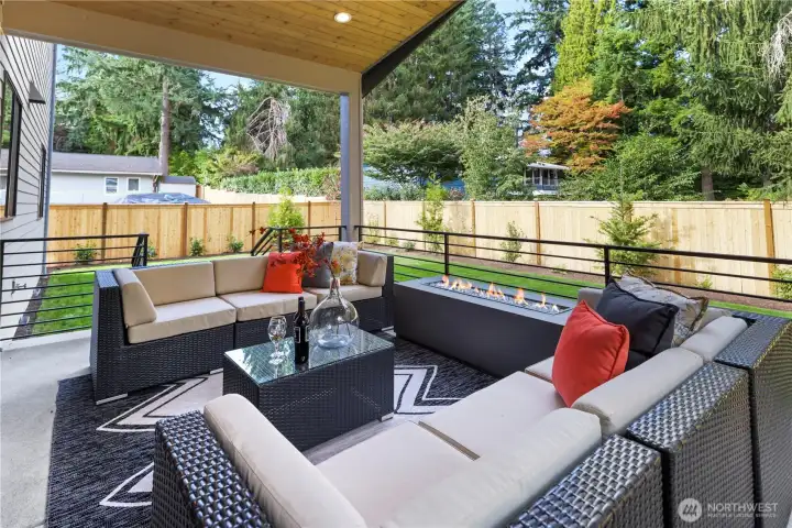 Wide sliding glass door leads to the large, vaulted and covered outdoor patio. Dedicated gas line for the fire table and another for a BBQ. Direct access down a few steps to the grassy, fully-enclosed backyard.