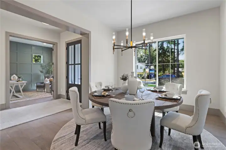 Elegant dining room is perfect for a round table. Sun-filled room off the entry with chandelier. niched space on the unseen wall opposite the window for an heirloom furniture piece.