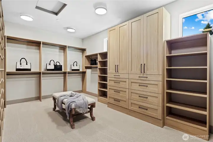 Stunning owner's walk-in closet with statement cabinetry, drawers, hanging, cubbies and shelves. Wonderful natural light from two westerly windows. This photo only shows a portion of the closet.