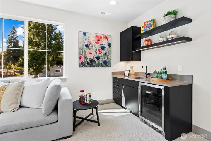 Big beautiful sun-kissed bonus room. Entertainer's bar with slab quartz countertops, bar sink, upper cabinet, base cabinet with drawers, and open shelving with LED lights. Under counter beverage chiller.
