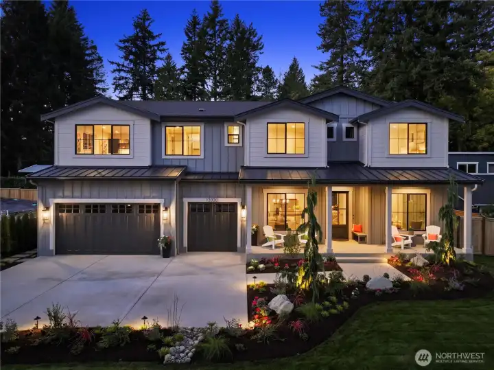 Such a gorgeous home all lit up with accent and pathway lighting. Robust landscaping with fall color and sprawling front lawn. It's a showstopper in the evening.