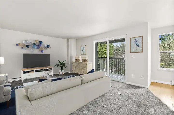 Virtually staged living room with large slider to private deck