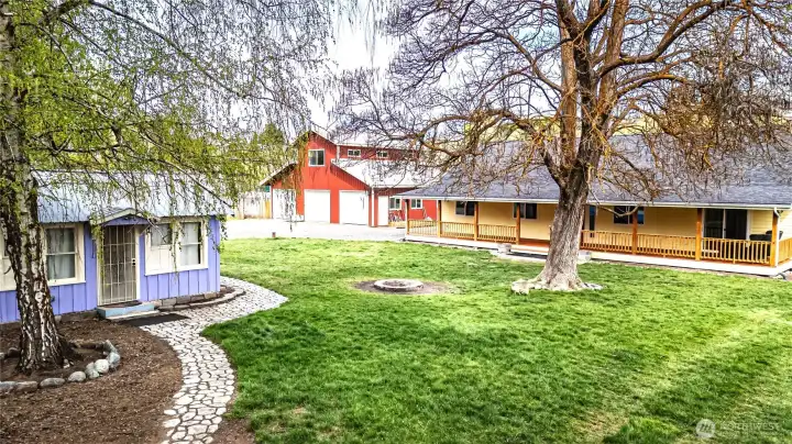 Beautiful oasis near Cashmere features a rambler with a covered porch, huge shop, and a cute original cottage.