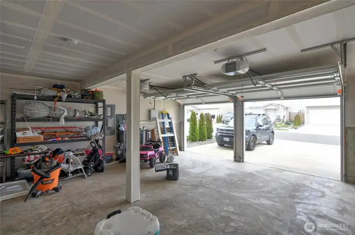 Big garage with two garage door openers.