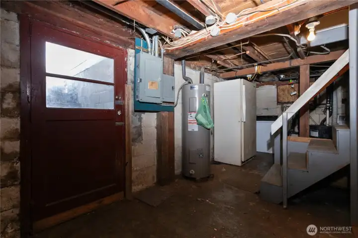 water heater, electrical panel and stair access to the outside
