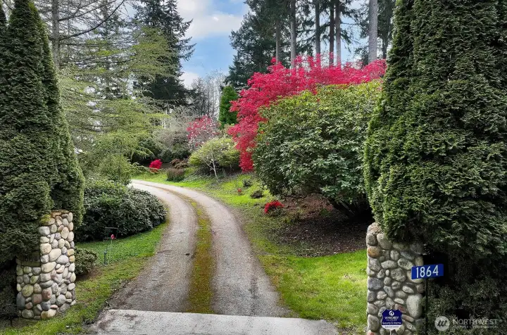 As you pull up to the driveway there is a cedar hedge with posts leading to a semi circular driveway.