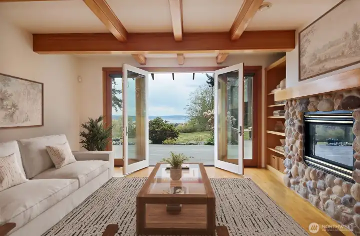 Comfortable living room with propane insert fireplace.  There are built ins to display and create order.  The beamed ceilings are beautiful.  Virtual Staging.