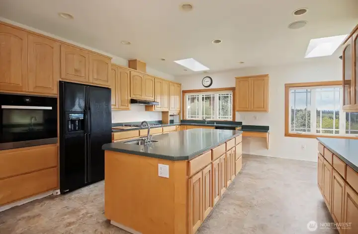 Spacious kitchen for the cook.  Durable vinyl flooring and Corian countertops & new propane cooktop...plus room for a breakfast table!