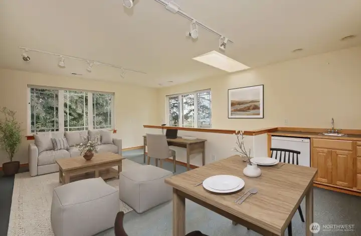 Upstairs studio space above the garage offers a sink, mini fridge and half bath.  Virtually staged.