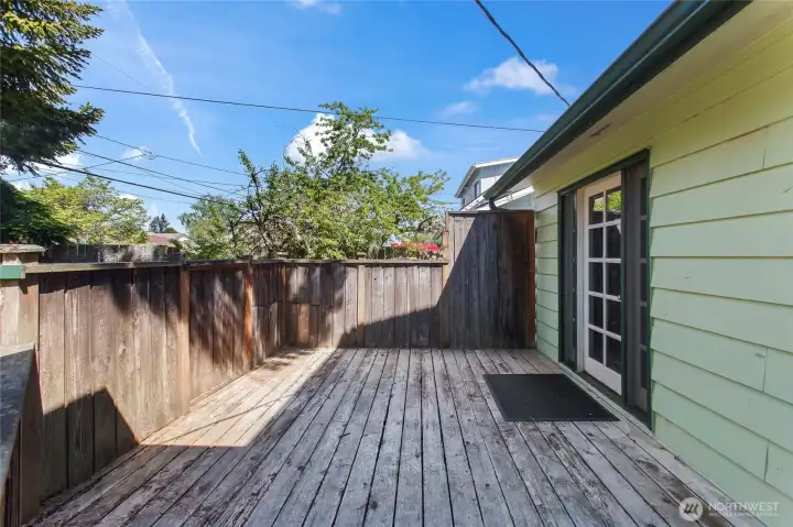 A patio off the front of the home to the left with dining room access
