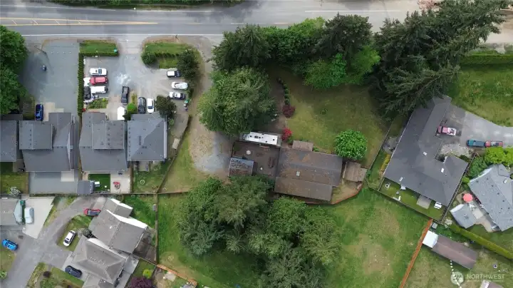 Aerial view. Wooded along the road.