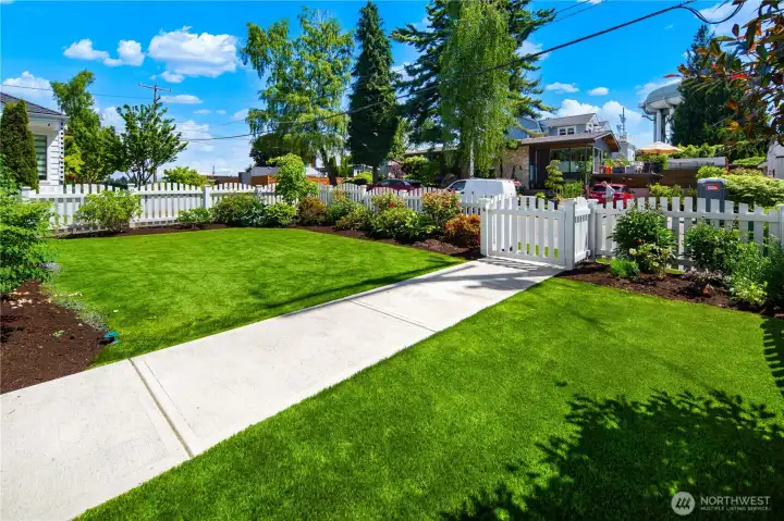Enjoy fully fenced front and back yards with easy-maintenance artificial turf, entertaining patio, mature landscaping, and room to play.
