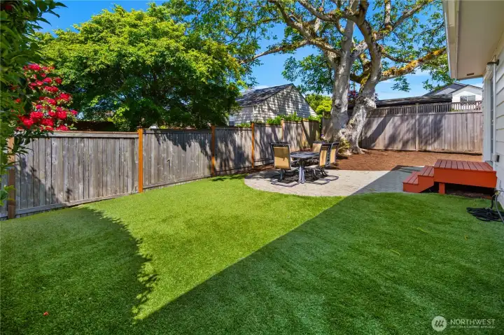 Enjoy fully fenced front and back yards with easy-maintenance artificial turf, entertaining patio, mature landscaping, and room to play.