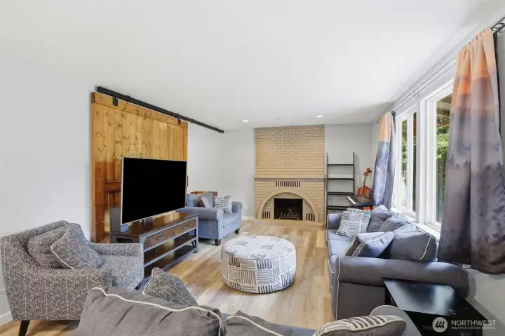 Living room with wood burning fireplace.