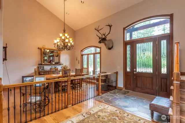 Vaulted and tile entry with view of formal dining.