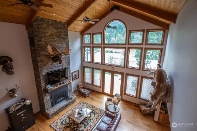 Massive wall of windows floods open living area with light and view of the river