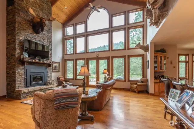 Stacked field stone double story fireplace anchors great room