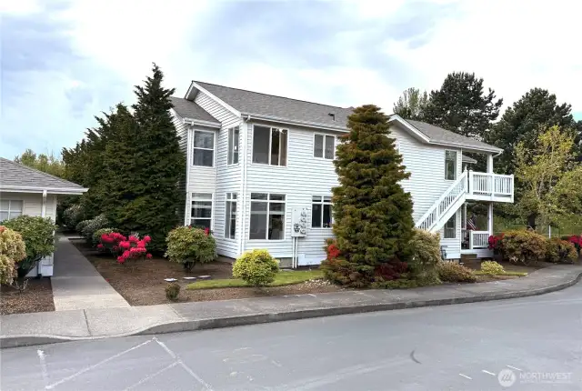 View of sidewalk with access to the garage man door between personal garages and units.
