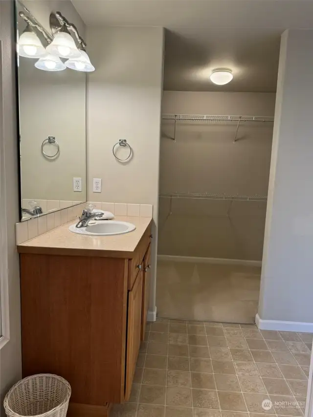 AS YOU SEE IT NOW  ~~ Showing first of the two sink areas...with spacious walk-in closet.... and don't miss the Linen Closet behind the door into the bath.