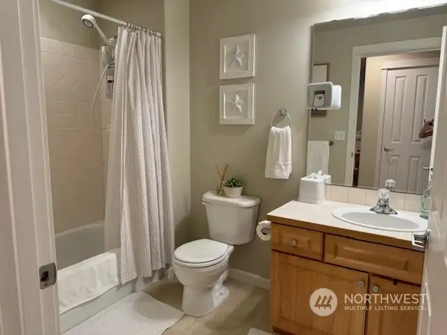 Guest bathroom with tub and shower.