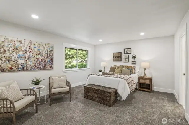 The expansive primary suite features three closets.