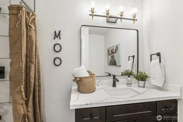 New lighting and fixtures elevate the luxury feel of the primary bathroom.