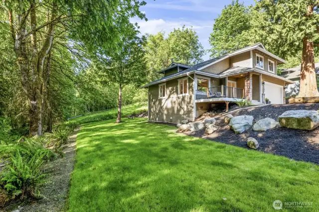 A spacious side yard runs along the greenbelt, offering ample room for yard games, entertaining, and enjoying the outdoors.