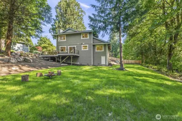 Expansive backyard with plenty of open space—perfect for a fire pit area, gardening, and outdoor gatherings.