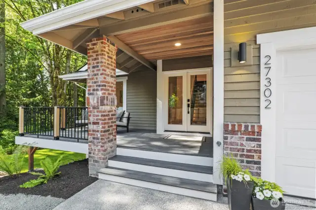New double entry front doors, partially covered front porch, and a new Trex deck with modern railing