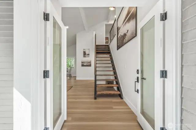 Step inside to soaring vaulted ceilings and a stunning custom staircase.