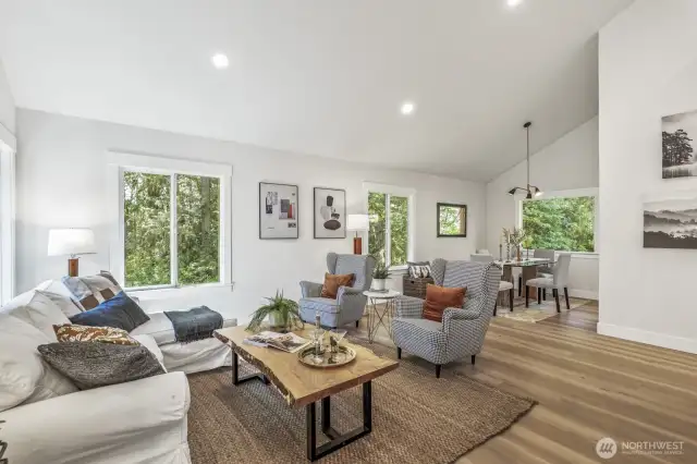 Living room just off the foyer, featuring fresh interior paint and new LVP flooring that extend throughout the entire main living space.