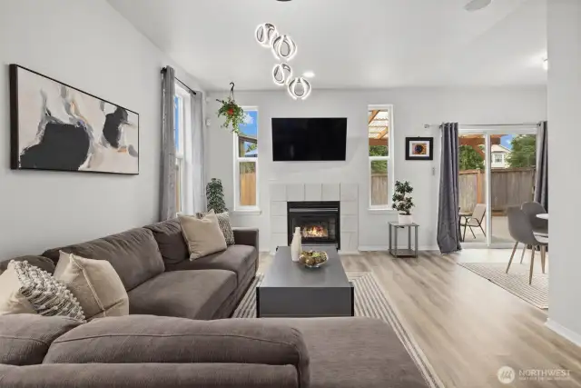 Spacious Family Room featuring gas fireplace, built in shelving, ample windows maximizing natural light overlooking your private backyard.