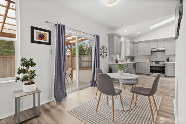 Breakfast nook leads to the new covered pergola outdoor living space.