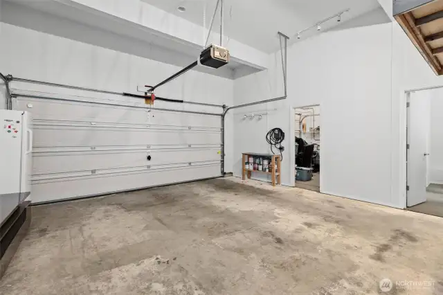 3 Bay Garage. 3rd Bay has been converted to a flex space through the door on the left and an office through the door on the right of the image. The garage door rails and system are in tact & can easily convert back to 3rd car garage bay.