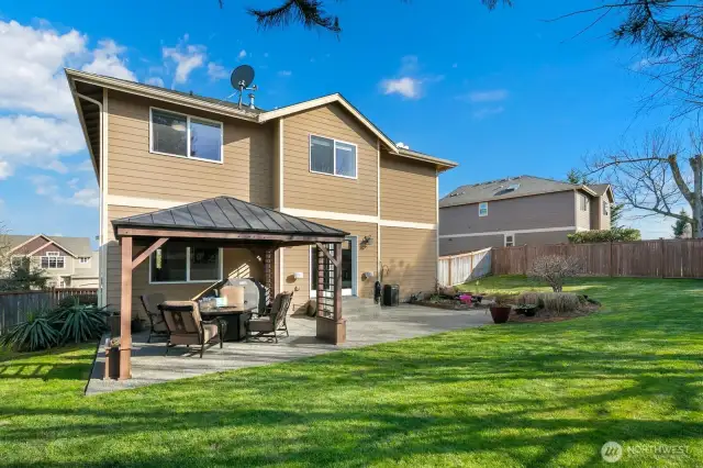 Fully fenced yard with large patio and gazebo.  Perfect play yard with gardening space and year round enjoyment with the gazebo!