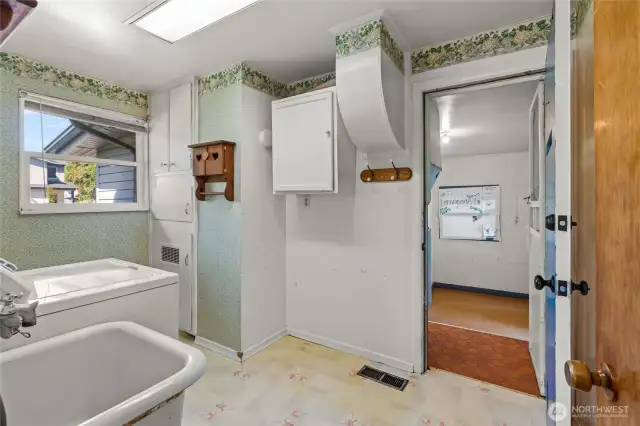 Utility room leads into enclosed, heated storage space