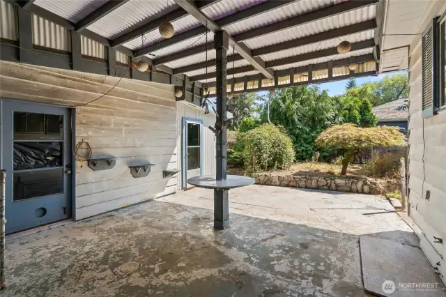 Covered patio connects the house to the shop