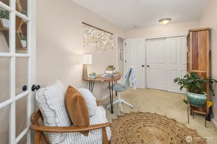 French doors open onto the bonus room, from the primary bedroom.