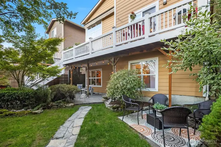 Views of the upper deck spanning the entire length of the main floor, with steps leading down to a very private back yard.