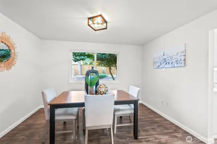 Adjacent to the living room, the dining area provides an intimate setting with views of the backyard. Its proximity to the kitchen makes entertaining seamless.
