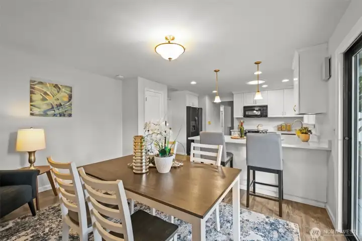 Another view of this versatile area highlights its open connection to the kitchen. With plenty of natural light and room to gather, it works beautifully as either a dining space or an informal family room.