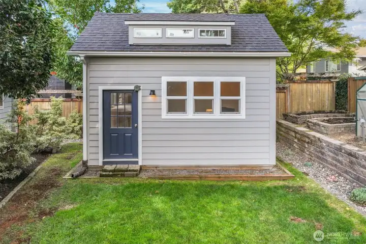 From the backyard, the detached building shows its thoughtful design and charm, adding tremendous versatility to the property.